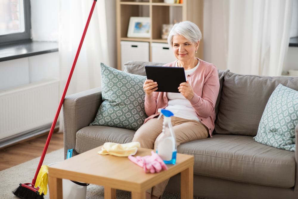 Featured image showing an older women sitting in a clean house having a video chat with loved-ones.